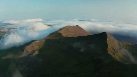 Aerial view of the mountains in the clouds at sunset. Faroe islands Stock Footage 202169301