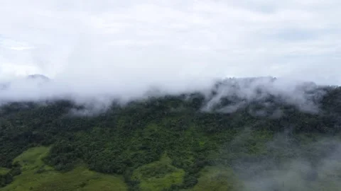 The aerial view of the mountains covered in clouds looks beautiful, piercin.. Stock Footage 301686896