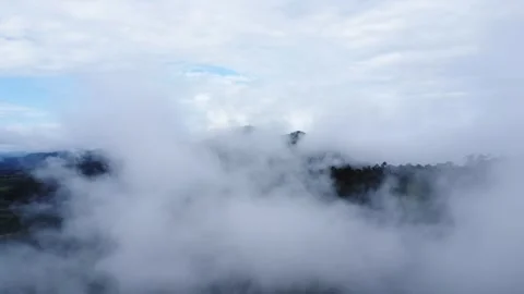 The aerial view of the mountains covered in clouds looks beautiful, piercin.. Stock Footage 301687751