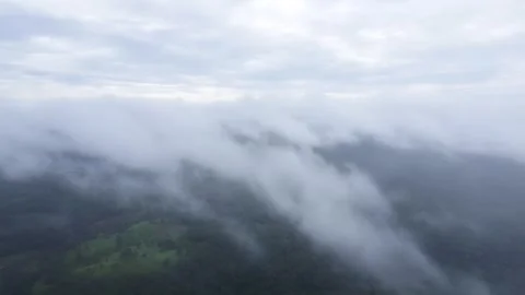 The aerial view of the mountains covered in clouds looks beautiful, piercin.. Stock Footage 301689040