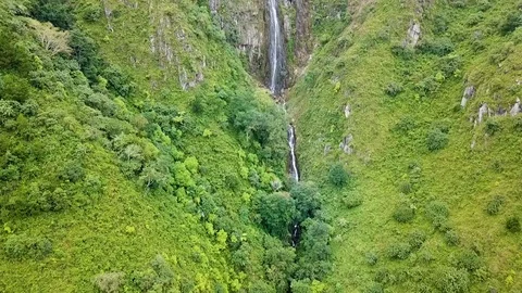 Aerial view of mountains covered forest, waterfall and clouds. 스톡 동영상 101900860