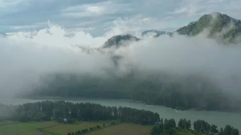 Aerial view of mountains, river in clouds and fog. Stock Footage 336101469