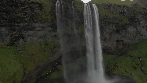 Aerial view to the mountains river flows through the valley and falls down Stock Footage 94352523