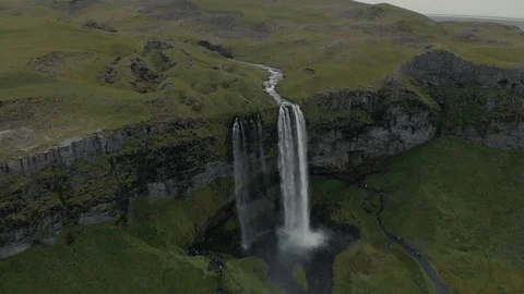 Aerial view to the mountains river flows through the valley and falls down Stock Footage 94352571