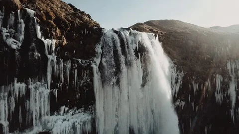 Aerial view to the mountains river flows through the valley and falls down. Stockbeeldmateriaal 97012221