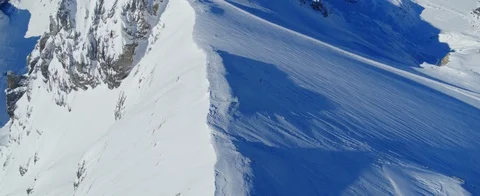 Aerial view of Mountaintop fully covered in snow in the Swiss Alps. Sunshine Stock Footage 121481833