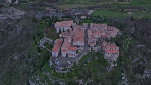 Aerial view of mountaintop rooftops lit by golden sun, Gourdon, France Stock Footage 310640353