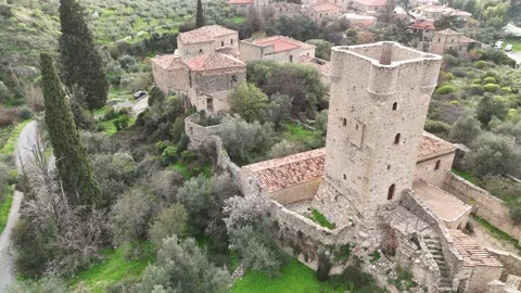 Aerial view of Mourtzinos Tower during sunset in the town of Kardamyli Video stock 302561253