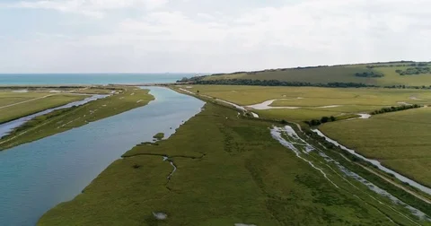 Aerial view of the mouth of a river and the sea in Southern England Stock Footage