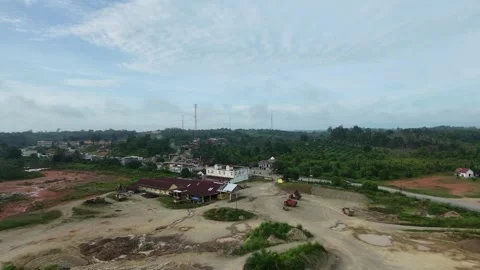 Aerial view moving away from an old factory toward a rural village Stock Footage 332500803