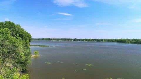 Aerial view moving back from the river with a blue sky 動画素材 136424823