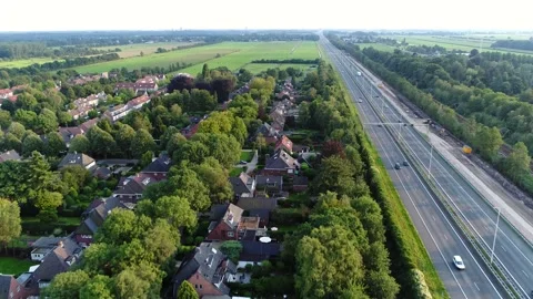 Aerial view moving backward over town with real estate located along highway 4k Stock Footage 150270766