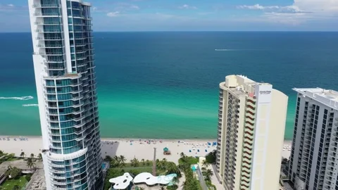Aerial View Moving Backwards from Ocean to Buildings Stock Footage 253002128