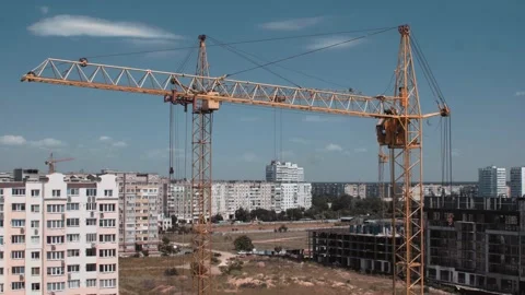 Aerial view of moving constructor crane from a drone Stock Footage 143562653