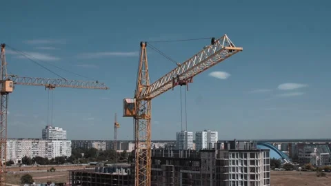 Aerial view of moving constructor crane from a drone Stock Footage 143562664
