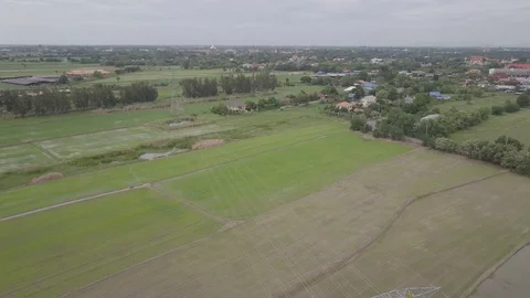 Aerial view moving down of high voltage electricity pylon in farmland Thailand Stock Footage 92110500