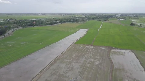 Aerial view moving down of high voltage electricity pylon in farmland Thailand Stock Footage 92112192