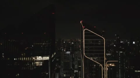 Aerial View Moving Down Modern Building at Night in Bangkok, Thailand Stock Footage 333597935