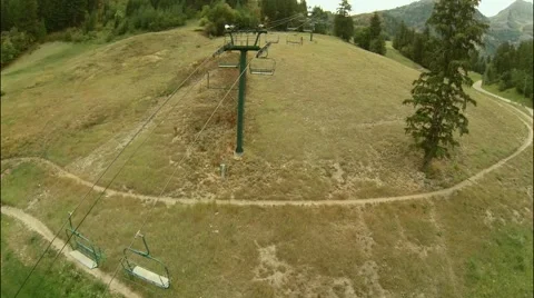 Aerial view of moving but empty chair lift Stock Footage 42928710