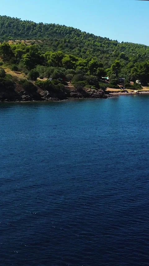 Aerial view moving forward and rising over sea to coast, Greece Stock Footage 342238408