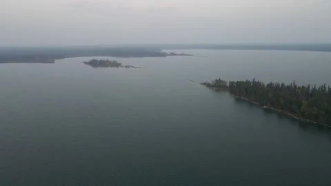 Aerial view moving forward high above a large lake with islands and points  Stock Footage 255658417