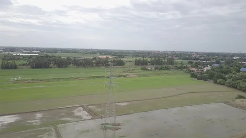 Aerial view moving over high voltage electricity pylon in farmland Thailand Stock Footage 92111300