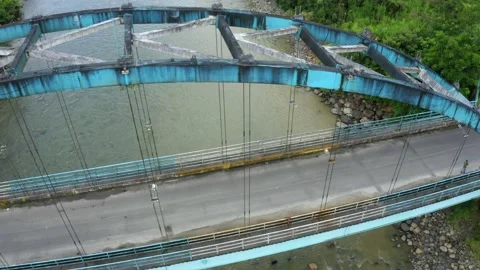 Aerial view, moving from the side towards a top view of a metal truss bridge Stock Footage 160319963