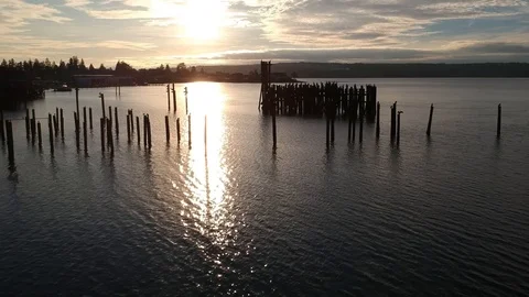 Aerial view moving slowly over water with evening sun reflecting on ripples Video stock 101861333