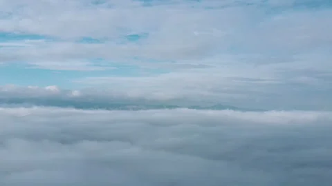 Aerial view of moving white clouds blue sky scenic in winter time Stock Footage 293670834