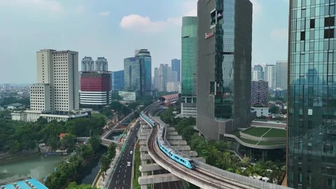 Aerial view of MRT train on elevated tracks through Jakarta, Indonesia. Stock Footage 340634102