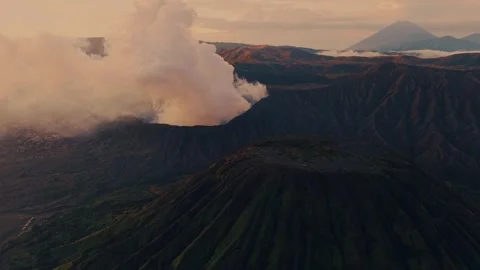 Aerial view of Mt. Bromo volcano with smoke at sunrise in East Java, Indonesia Stock Footage 297830840