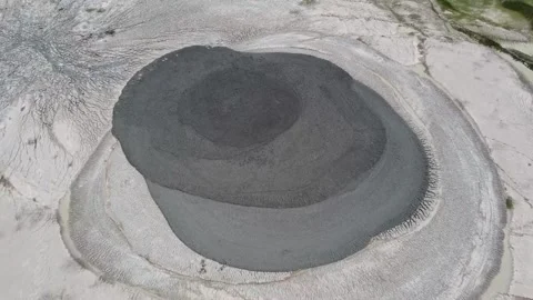 Aerial view of a mud volcano with dark gray mud center at Blora, Indonesia Video stock 279754730