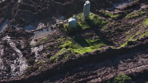 Aerial view of a muddy construction site with utility boxes Stock Footage 341257655
