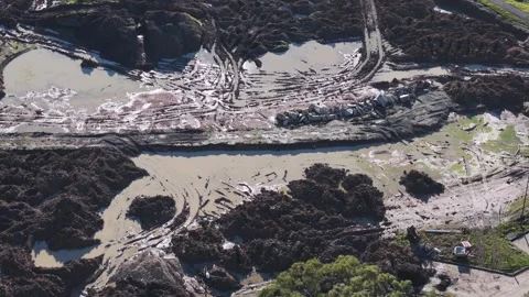 Aerial view of a muddy construction site with large soil piles Stock Footage 341265405