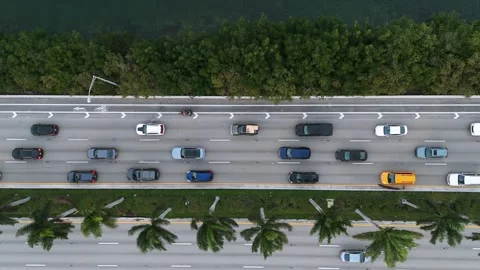Aerial view of multi-lane and two-way road with colorful cars. Road flanked by Stock Footage 262265626