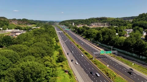 Aerial view of multi-lane highway traffic winding through lush... Video stock 340657887