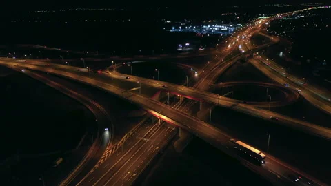 Aerial view of a multi-level highway crossroad with moving cars at sunset. Stock Footage 200846687