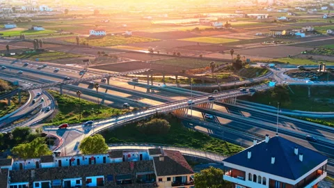 Aerial view of multi level highway interchange at sunset Stock-Footage 334859130