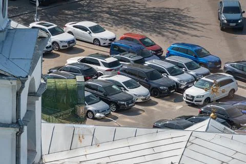 Aerial view of a multi-level rooftop parking area with parallel parked cars.. Stock Photos