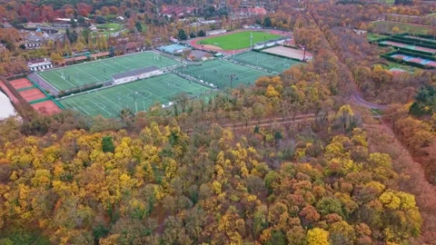 Aerial View of Multi-Sport Complex Surrounded by Autumn Forest Near Paris Stock Footage 323907921