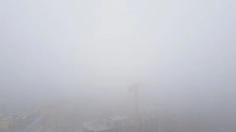 Aerial view. A multi-storey brick house in the city in a fog. A construction Stock Footage 83483738