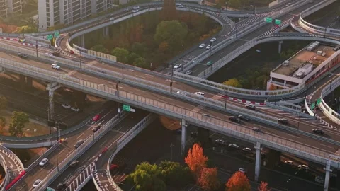 Aerial view of multilevel highway interchange with car and bus traffic in China Stock Footage 324699180