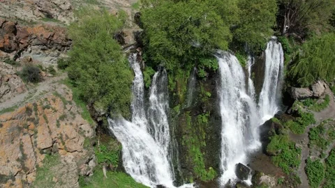 Aerial view of multiple cascades of Shaki waterfall over green rocks Stock Footage 342847442