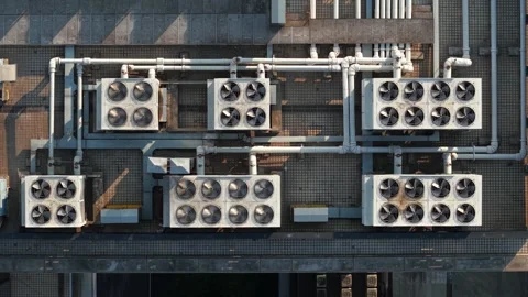 Aerial view of multiple cooling units situated on a rooftop. The system features Vídeo Stock 310117494
