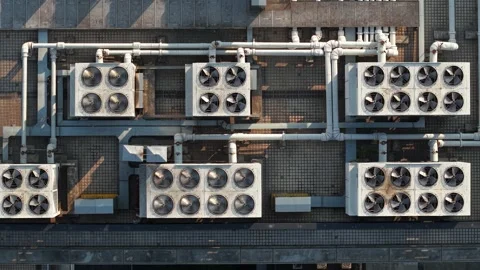 Aerial view of multiple cooling units situated on a rooftop. The system features Video stock 313582637