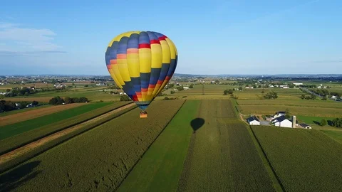 Aerial view of multiple hot air balloons taking off at a festival Stock Footage 125920505