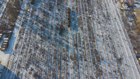 Aerial view of multiple parallel railway tracks covered in snow at the Socola Video stock 327403666