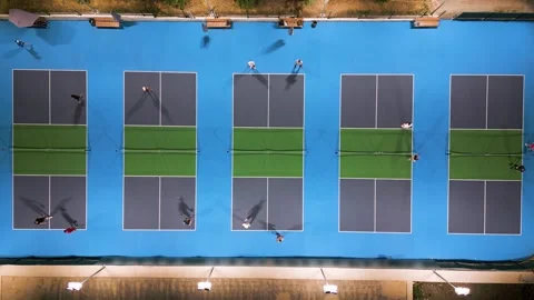Aerial view of multiple pickleball courts with players in action, top down Stock Footage 318184024