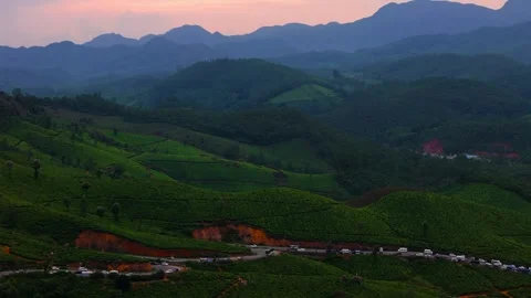 Aerial View of Munnar at Sunset Showcasing Winding Roads, Lush Tea Plantations Видео 341311583
