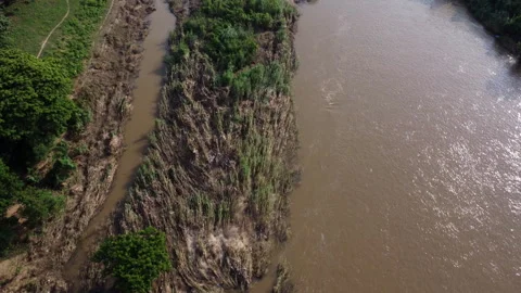 Aerial view of murky brown forest water flowing in a river in the rainy season. Stock Footage 251707904